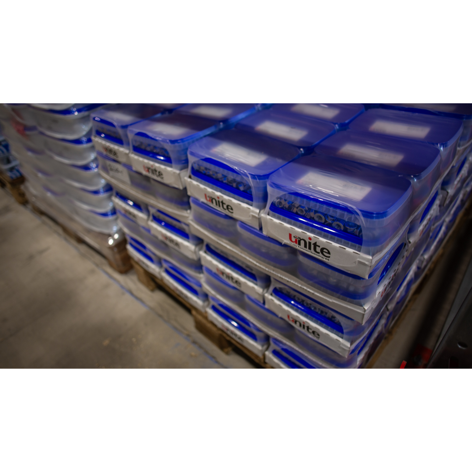Stacked Unite fastener boxes on pallets in the warehouse.